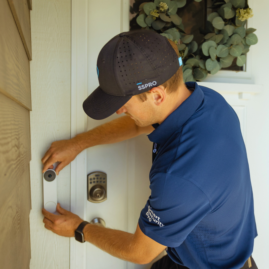 Installer setting up a video doorbell at a home