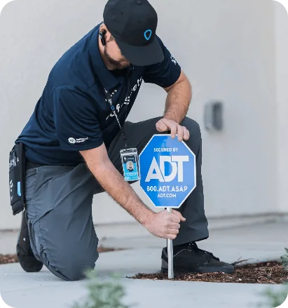 Installer placing ADT secured yard sign