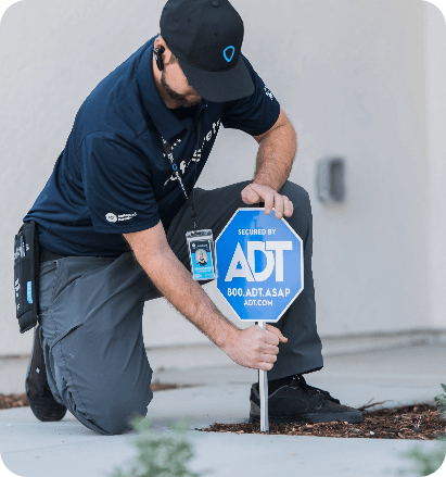 Installer placing ADT secured yard sign